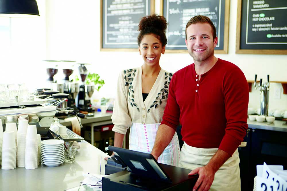 business people standing at cash register