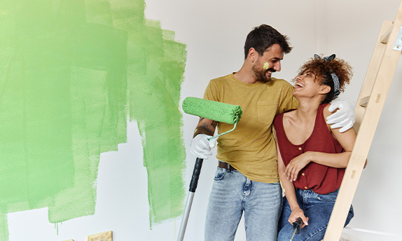 Couple painting a room paid for by a HELOC