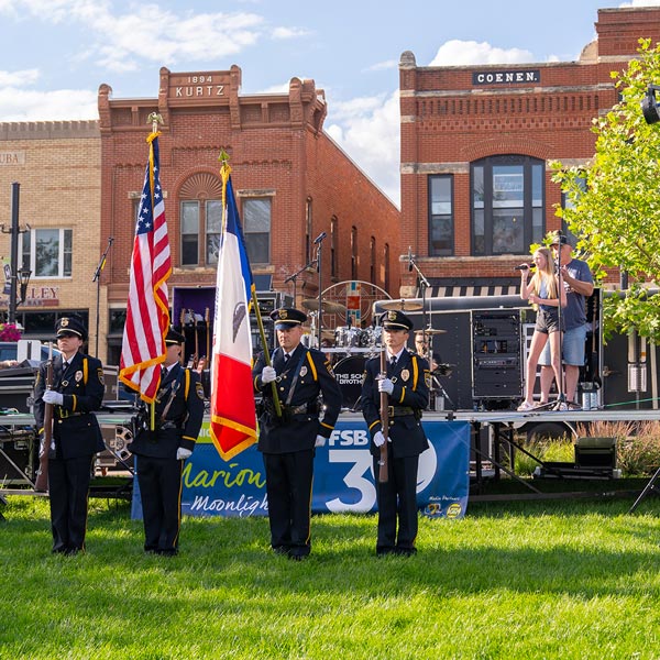 A color guard presents flags during Marion by Moonlight’s night three celebration in Central Plaza.
