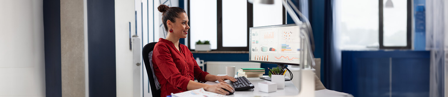 Woman working at a computer in a modern office, highlighting the best CD Rates in Iowa.