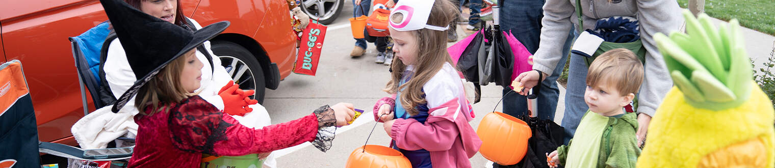 Children in Halloween costumes receive candy at Marion Monster Mash.