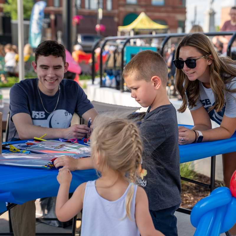 FSB volunteers help children with crafts and balloon animals during night 4 of Marion by Moonlight