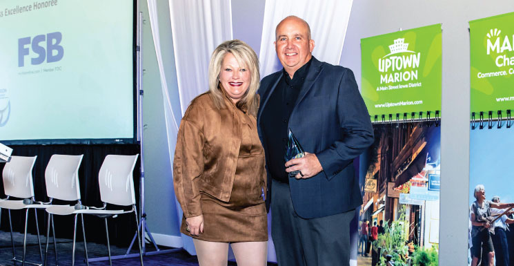 Steve Neighbor accepts the first-ever Marion Chamber of Commerce Business Excellence Award on behalf of Farmers State Bank (FSB).