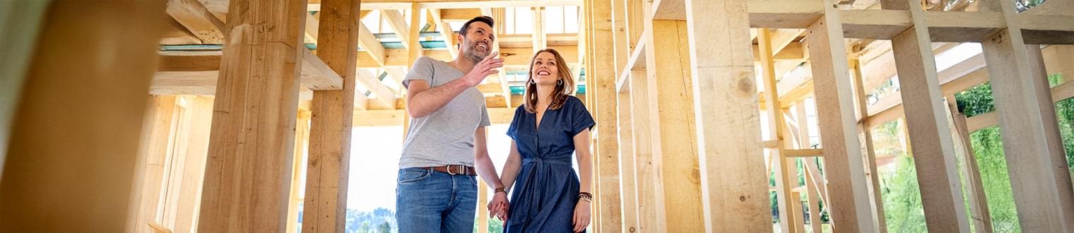 Couple reviewing blueprints for Home Construction Loans in Eastern Iowa
