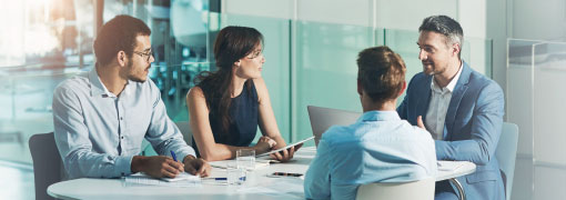 Business team meeting around a table to discuss fraud protection strategies and prevention.