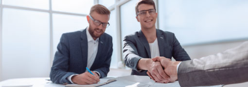 Business owner shaking hands with lender after business loan approval meeting