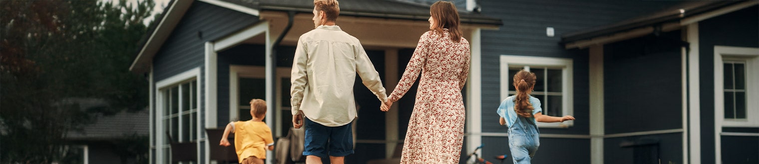 A family walks toward a home, symbolizing USDA loans in Eastern Iowa for rural buyers.