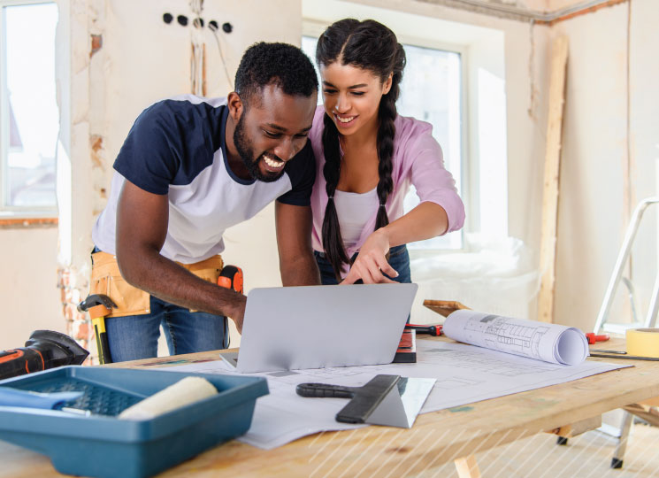 Homeowners reviewing renovation plans for a home equity loan